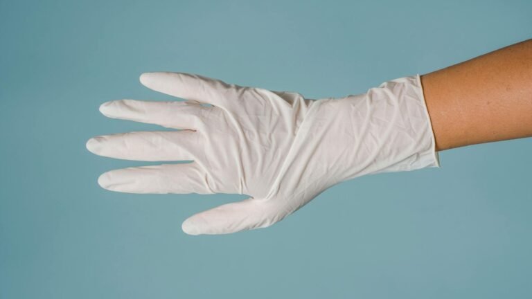 one hand wear white nitrile glove